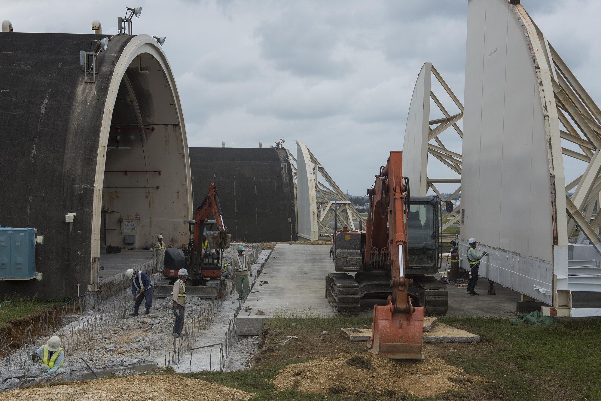 Construction crews replace doors to a hangar Nov. 1, 2016, at Kadena Air Base, Japan. Maintaining these hardened shelters ensures Kadena assets are protected and maintains mission readiness. (U.S. Air Force photo by Airman 1st Class Corey M. Pettis/Released)