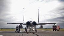 A U.S. Air Force F-15E Strike Eagle from RAF Lakenheath stands parked on the flightline Oct. 28, 2016, on RAF Mildenhall, England. The 100th Civil Engineer Squadron power production shop consistently tests the Mobile Aircraft Arresting System, but once a year they conduct its recertification. (U.S. Air Force photo by Senior Airman Christine Halan)