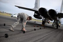 U.S. Air Force Tech. Sgt. Patrick Costello, 100th Civil Engineer Squadron power production NCO in charge, unties a rope from a Mobile Aircraft Arresting System cable Oct. 28, 2016, on RAF Mildenhall, England. The power production shop worked with the 48th Fighter Wing from RAF Lakenheath and the 100th Civil Engineering Squadron Fire Department from RAF Mildenhall during the MAAS certification process. (U.S. Air Force photo by Senior Airman Christine Halan)