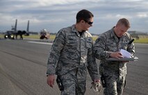 U.S. Air Force Tech. Sgt. Patrick Costello, left, 100th Civil Engineer Squadron power production NCO in charge, and U.S. Air Force Staff Sgt. Ryan Albert, 100th CES power production craftsman, review paperwork Oct. 28, 2016, on RAF Mildenhall, England. The power production shop conducts a certification of the Mobile Aircraft Arresting System on an annual basis. (U.S. Air Force photo by Senior Airman Christine Halan)