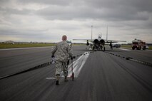 U.S. Air Force Staff Sgt. Ryan Albert, 100th Civil Engineer Squadron power production craftsman measures the distance the Mobile Aircraft Arresting System took to stop an RAF Lakenheath F-15E Strike Eagle Oct. 28, 2016, on RAF Mildenhall, England. The power production shop worked with the RAF Lakenheath 48th Fighter Wing and the RAF Mildenhall 100th Civil Engineer Squadron Fire Department during the MAAS certification process. (U.S. Air Force photo by Senior Airman Christine Halan) 