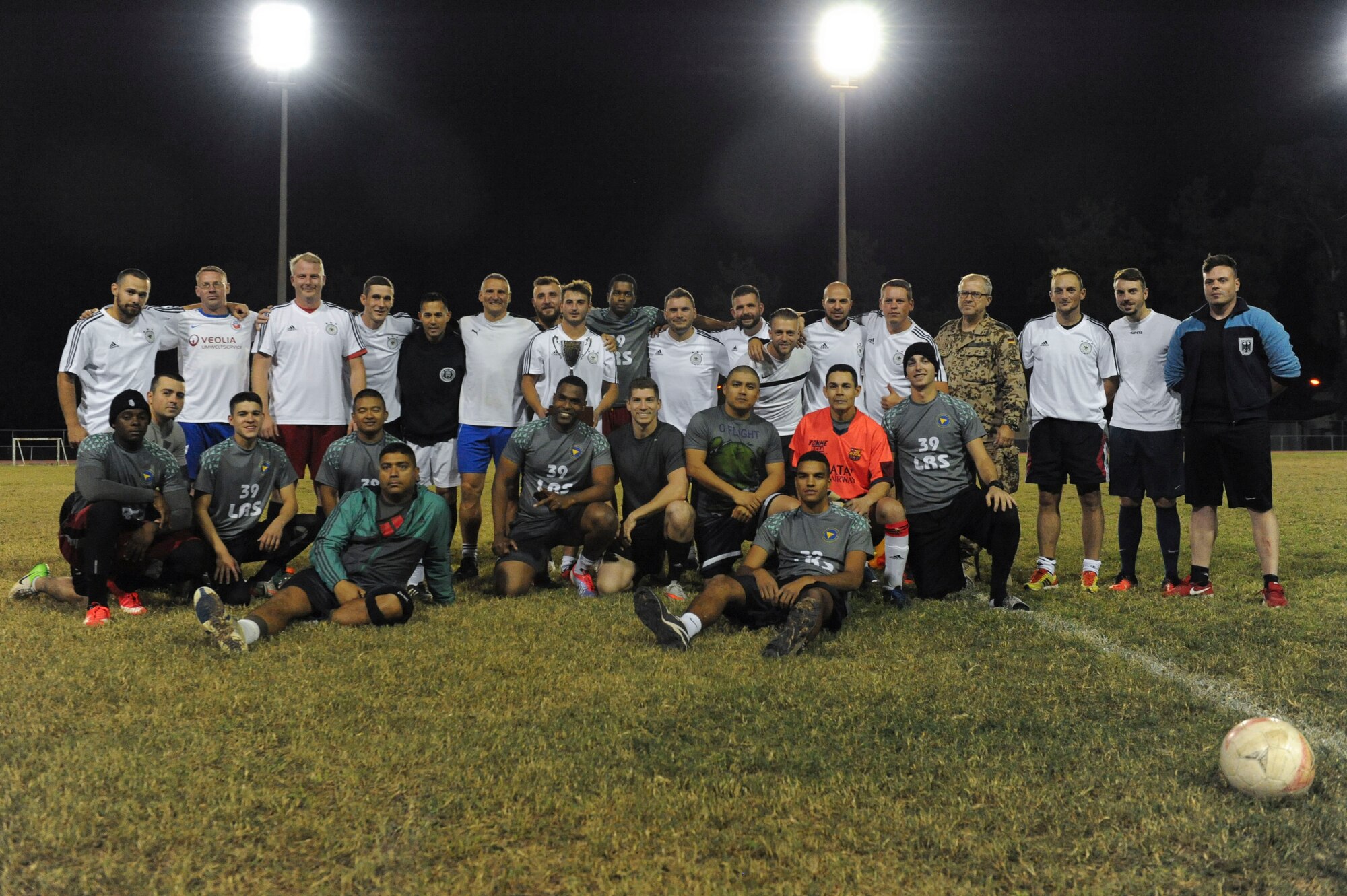 The 39th LRS and NATO intramural soccer teams pose for a photo Nov. 1, 2016, at Incirlik Air Base, Turkey. The game ended with a 5-3 shootout victory for the NATO team. (U.S. Air Force photo by Airman 1st Class Devin M. Rumbaugh)