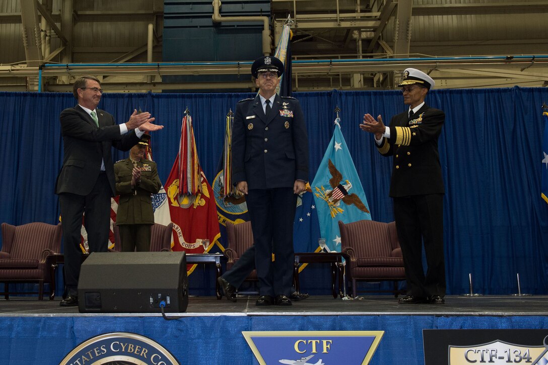 Defense Secretary Ash Carter applauds as Air Force Gen. John E. Hyten assumes the reins of U.S. Strategic Command from Navy Adm. Cecil D. Haney during a ceremony at Offutt Air Force Base, Neb., Nov. 3, 2016.