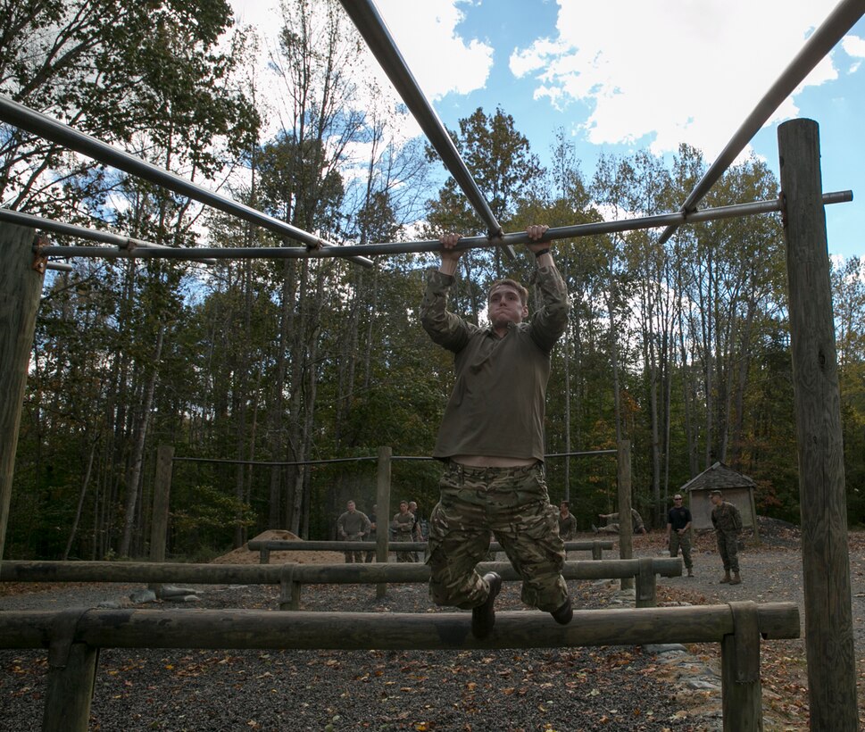 Royal Marine Haydn Wood, 43 Fleet Protection Group Royal Marines, prepares to swing up onto double bars at The Basic School obstacle course during Exercise Tartan Eagle 16 Phase II, aboard Marine Corps Base Quantico, Va., Oct. 22.  U.S. Marines, sailors and Royal Marines had to overcome the obstacle course and then proceed to take on the endurance course which includes a six-mile trail with multiple obstacles to overcome. (Official U.S. Marine Corps photo by Sgt. Calvin Shamoon/ Released)