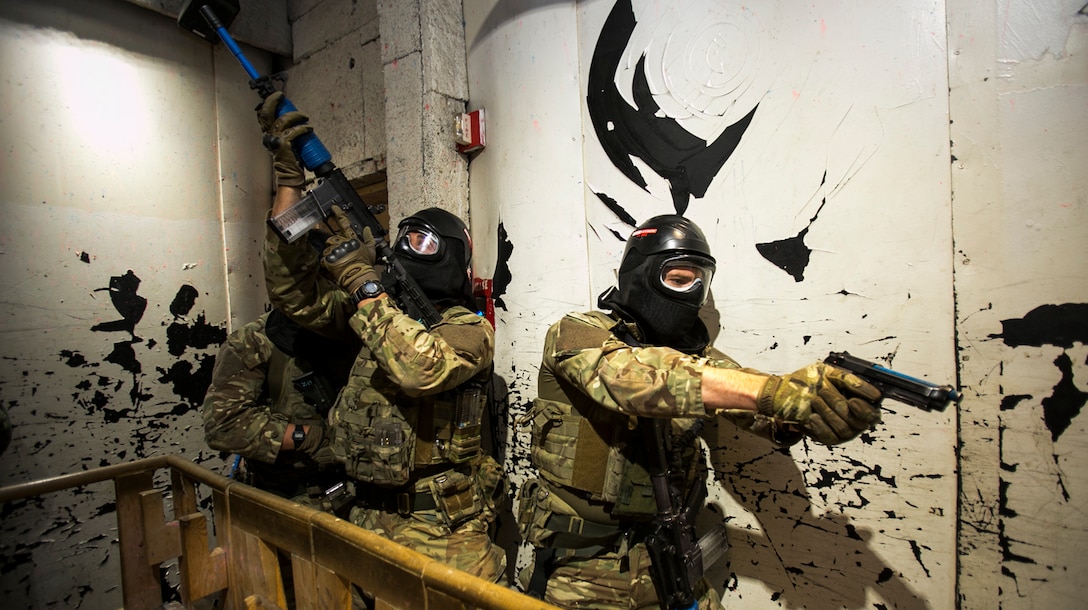 Royal Marine Benjamin Clark (left), provides cover for Royal Marine Jake Mickleburgh, 43 Fleet Protection Group Royal Marines, as they make their way down the hall and around a ladder well inside a live-fire shoot house for Exercise Tartan Eagle 16 Phase II, aboard Naval Support Activity Northwest Annex, Chesapeake, Va., Oct. 25. Marines and sailors from Marine Corps Security Force Battalions Bangor, Wa., and Kings Bay, Ga., and members of 43 FPGRM spent the day using simulation rounds in a live-fire house against opposing forces to simulate close-quarters battle environment while exchanging tactics focusing on certain situations. (Official U.S. Marine Corps photo by Sgt. Calvin Shamoon/ Released)