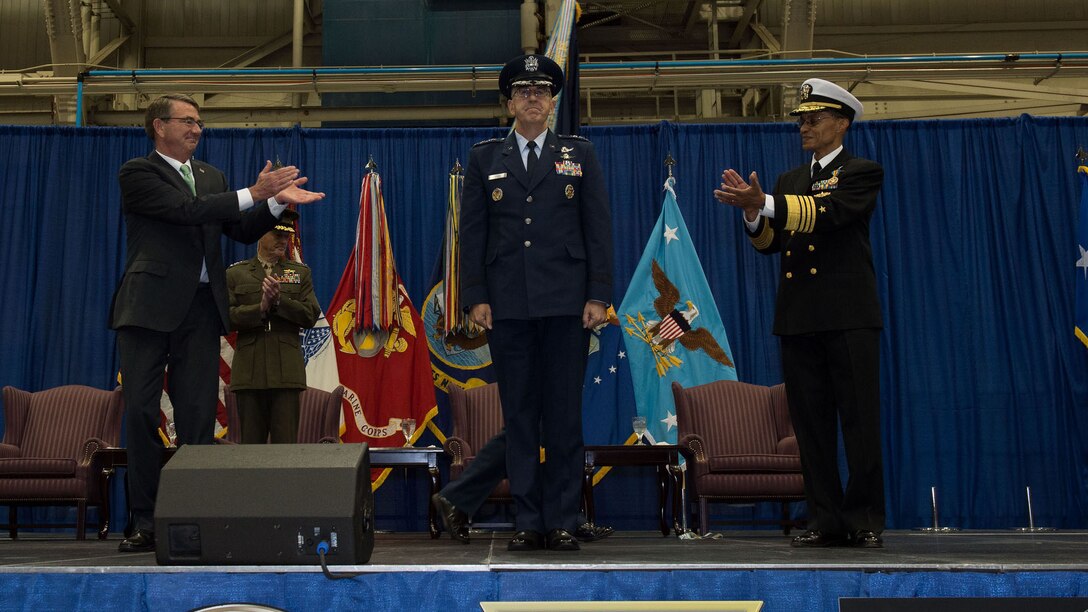 Defense Secretary Ash Carter applauds as Air Force Gen. John E. Hyten assumes the reins of U.S. Strategic Command from Navy Adm. Cecil D. Haney during a ceremony at Offutt Air Force Base, Neb., Nov 3, 2016.