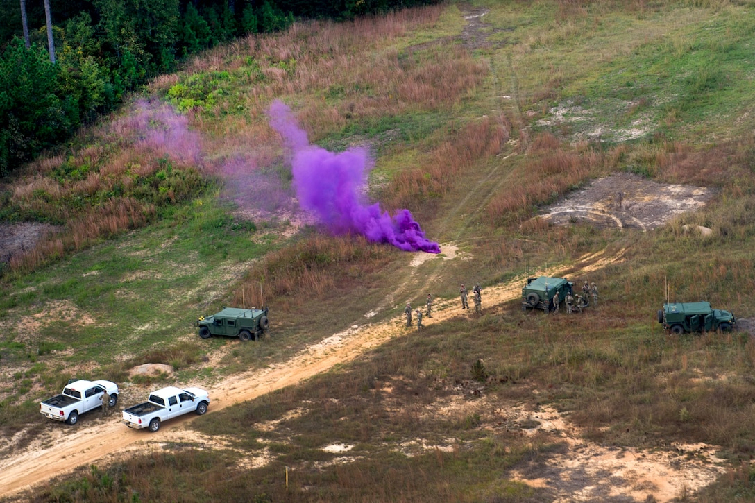 Army Special Forces soldiers use a smoke grenade to signal a UH-60 Black Hawk medical evacuation helicopter for a medical airlift during Southern Strike 17 at the Gulfport Combat Readiness Training Center, Miss., Oct. 26, 2017. Air Force photo by Airman 1st Class Sean Carnes