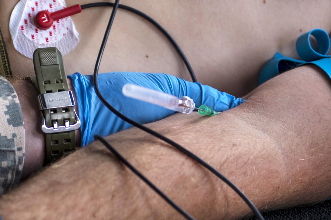 Army Sgt. Rickie Smith simulates attaching an intravenous line to a role-player acting as a patient during a medical evacuation scenario for Southern Strike 17 at Camp Shelby Joint Forces Training Center, Miss., Oct. 26, 2016. Smith is a flight medic assigned to the Mississippi Army National Guard’s Golf Company, 1st Battalion, 168th Aviation Regiment. Air Force photo by Airman 1st Class Sean Carnes