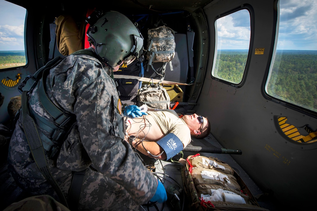 Army Sgt. Rickie Smith checks vital signs on a role player acting as a patient during a medical evacuation, part of Southern Strike 17 at Camp Shelby Joint Forces Training Center, Miss., Oct. 26, 2016. Smith is a flight medic assigned to the Mississippi Army National Guard’s Golf Company, 1st Battalion, 168th Aviation Regiment. Air Force photo by Airman 1st Class Sean Carnes
