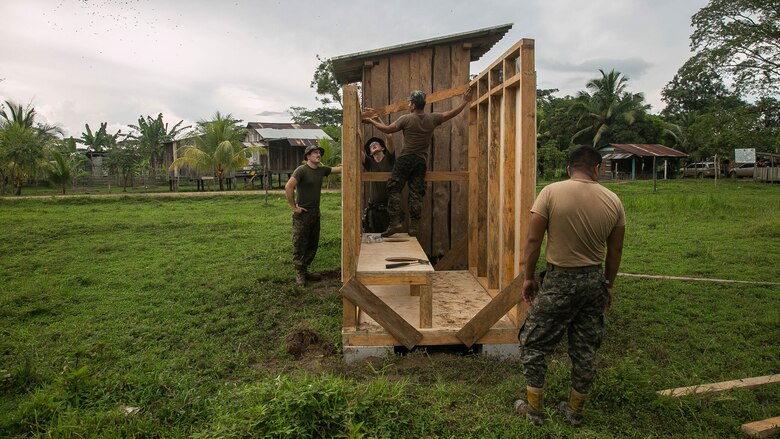 U.S. Marines with Special Purpose Marine Air-Ground Task Force - Southern Command and Honduran Army engineers work together to connect the walls of a restroom being built in Leimus, Honduras, Sept. 2, 2016. U.S. Marines and Sailors assigned to Special Purpose Marine Air-Ground Task Force-Southern Command participated in engineering projects, security cooperation and disaster relief preparation in Belize, El Salvador, Guatemala and Honduras. 