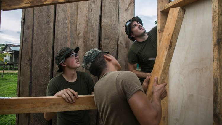 U.S. Marine Cpl. Cody Simons, left, a native of Scappoose, Oregon, and Cpl. Jacob Stewart, a native of Timber, Oregon, both combat engineers with Special Purpose Marine Air-Ground Task Force - Southern Command, work with a Honduran Army engineer on the wall of a restroom being built in Leimus, Honduras, Sept. 2, 2016. U.S. Marines and Sailors assigned to Special Purpose Marine Air-Ground Task Force-Southern Command participated in engineering projects, security cooperation and disaster relief preparation in Belize, El Salvador, Guatemala and Honduras. 