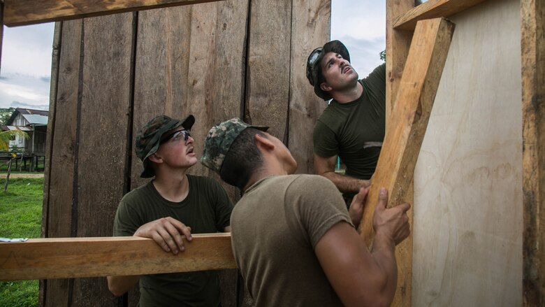 U.S. Marine Cpl. Cody Simons, left, a native of Scappoose, Oregon, and Cpl. Jacob Stewart, a native of Timber, Oregon, both combat engineers with Special Purpose Marine Air-Ground Task Force - Southern Command, work with a Honduran Army engineer on the wall of a restroom being built in Leimus, Honduras, Sept. 2, 2016. U.S. Marines and Sailors assigned to Special Purpose Marine Air-Ground Task Force-Southern Command participated in engineering projects, security cooperation and disaster relief preparation in Belize, El Salvador, Guatemala and Honduras. 