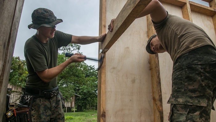 U.S. Marine Cpl. Cody Simons, a native of Scappoose, Oregon, and combat engineer with Special Purpose Marine Air-Ground Task Force - Southern Command, and Honduran Army engineer Darwin Garcia work together to connect the walls of a restroom being built in Leimus, Honduras, Sept. 02, 2016. U.S. Marines and Sailors assigned to Special Purpose Marine Air-Ground Task Force-Southern Command participated in engineering projects, security cooperation and disaster relief preparation in Belize, El Salvador, Guatemala and Honduras. 