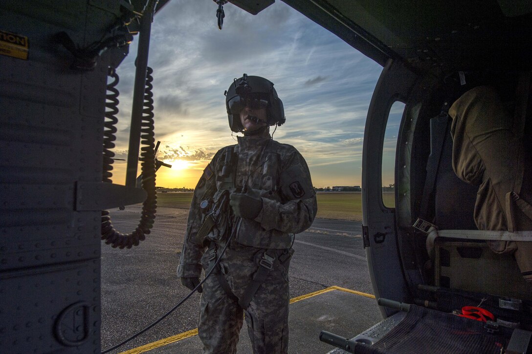 Army Sgt. Bradon Smith stands outside his UH-60 Black Hawk helicopter after landing at the Gulfport Combat Readiness Training Center, Miss., during Southern Strike 17, Oct. 26, 2017. Smith is a crew chief assigned to the Mississippi Army National Guard’s Golf Company, 1st Battalion, 168th Aviation Regiment. Air Force photo by Airman 1st Class Sean Carnes