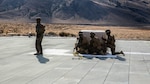 U.S. Marines with Combat Logistics Battalion 15, 1st Marine Logistics Group, and 3rd Battalion, 4th Marine Regiment, 1st Marine Division, wait by a 500-gallon drum of water to conduct a Helicopter Support Team drill at Mountain Warfare Training Center, Bridgeport, California, Oct. 25, 2016. The drum was taken into the Sierra Mesa Mountains to support Marines who are conducting field operations during Mountain Exercise 6-16. 