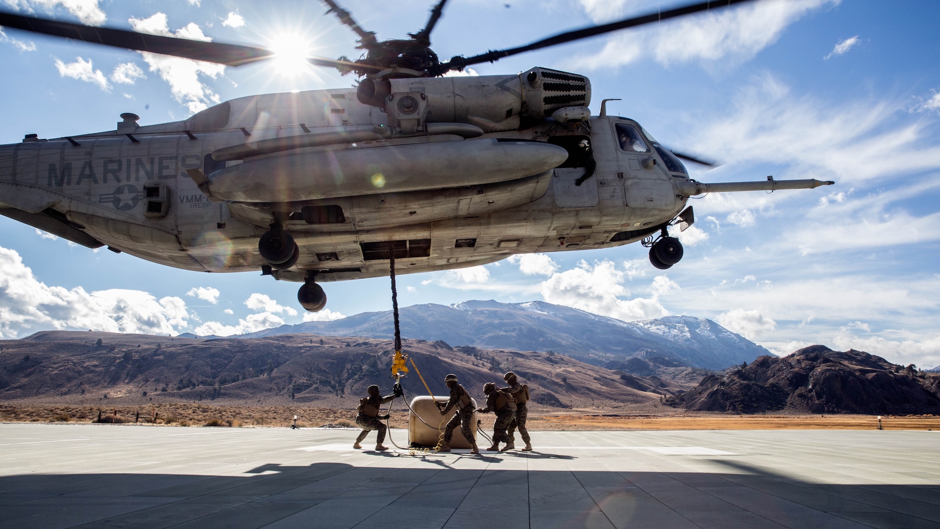 U.S. Marines with Combat Logistics Battalion 15, 1st Marine Logistics Group, and 3rd Battalion, 4th Marine Regiment, 1st Marine Division, strap a 500-gallon drum of water to a CH-53E Super Stallion, with Marine Heavy Helicopter Squadron 466, during a Helicopter Support Team drill at Mountain Warfare Training Center, Bridgeport, California, Oct. 25, 2016. The drum was taken into the Sierra Mesa Mountains to support Marines who are conducting field operations during Mountain Exercise 6-16. 
