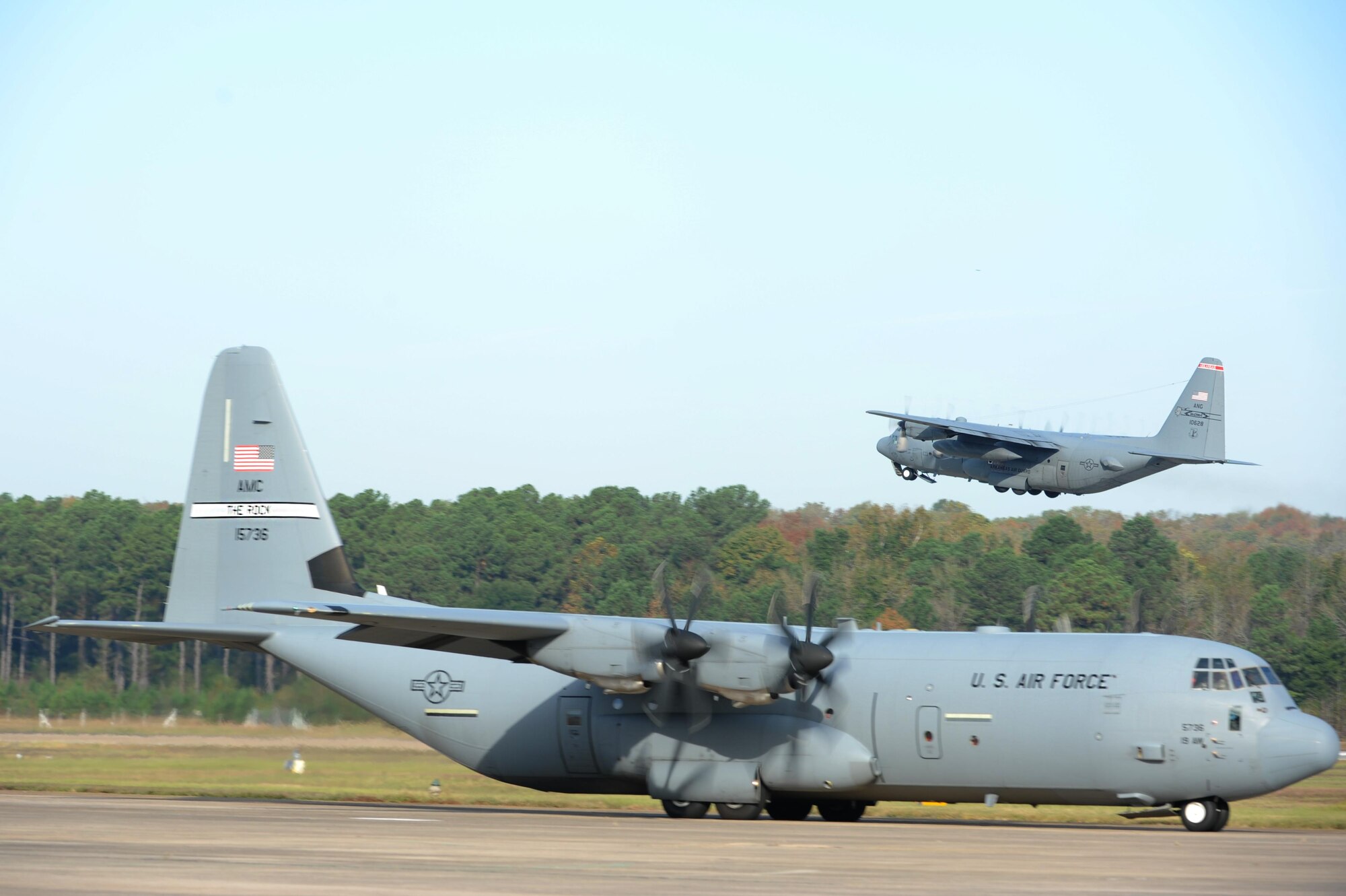 A C-130J takes off while another taxis on the flightline during an 11-ship C-130J formation Oct. 24, 2016, at Little Rock Air Force Base, Ark. The C-130J Hercules performs the tactical portion of the Combat Airlift mission. (U.S. Air Force photo by Airman Grace Nichols)