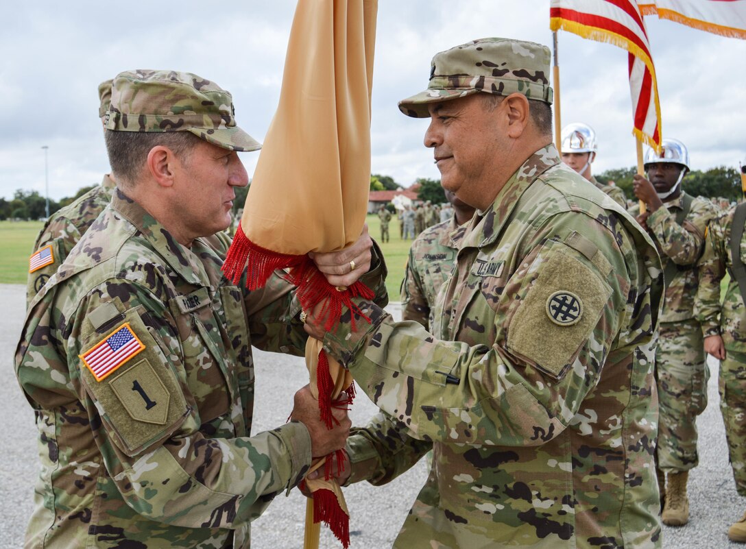 Col. Herman Ter Meer, the 4th Sustainment Command (Expeditionary) outgoing commander, passes the unit's colors to Maj. Gen. Mark Palzer, the 79th Sustainment Support Command commanding general, during a traditional passing of the colors at a change of command ceremony held at Fort Sam Houston, Texas, on Oct. 15, 2016.  (U.S. Army Photo by Spc. Eddie Serra)