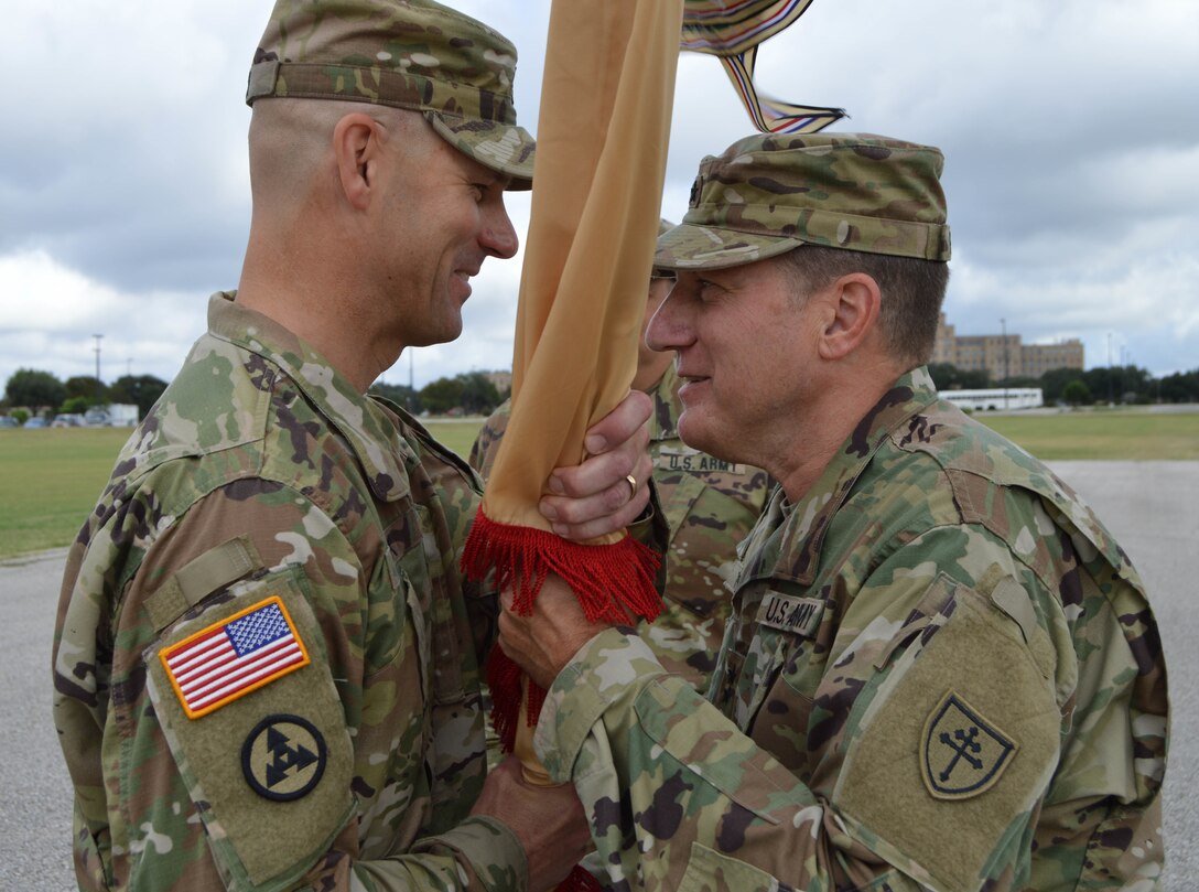 Brig. Gen. Alex Fink, the incoming commanding general of the 4th Sustainment Command (Expeditionary), receives the unit's colors from Maj. Gen. Mark Palzer, the 79th Sustainment Support Command's commanding general, during a traditional passing of the colors at a change of command ceremony held at Fort Sam Houston, Texas, on Oct. 15, 2016.  (U.S. Army Photo by Spc. Eddie Serra)