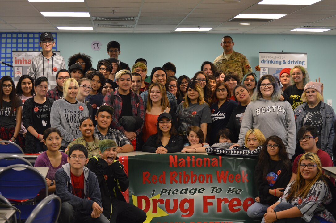 Students from the Henry Ford Academy in San Antonio, Texas, pose for a photo with U.S. Army Reserve Sgt. 1st Class Byran Johnson, a unit prevention leader (UPL) with the 4th Sustainment Command (Expeditionary) on Oct. 24, 2016, after he spoke with them about the dangers of gateway drugs in support of Red Ribbon Week.  (U.S. Army Reserve Photo by Sgt. Cassie Blakeney)