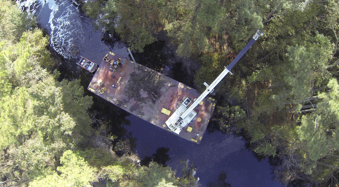 CHESAPEAKE, Va. -- Norfolk District Operations Branch personnel use a crane barge to remove downed trees along the Dismal Swamp Canal's Lake Drummond feeder ditch here October 27,2016. The trees came down during Hurricane Matthew, which inundated the area with water causing flooding, power outages and downed trees. (U.S. Army photo/Patrick Bloodgood)