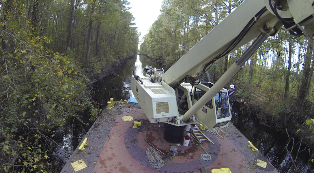 CHESAPEAKE, Va. -- Norfolk District Operations Branch personnel use a crane barge to remove downed trees along the Dismal Swamp Canal's Lake Drummond feeder ditch here October 27,2016. The trees came down during Hurricane Matthew, which inundated the area with water causing flooding, power outages and downed trees. (U.S. Army photo/Patrick Bloodgood)