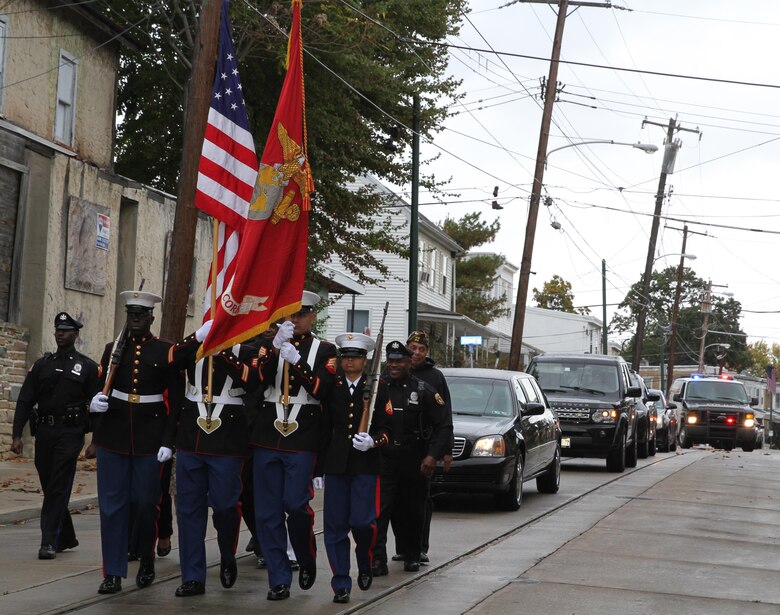 Marine reservists from Artillery Battery, 3rd Battalion, 14th Marine Regiment, carry the colors at the head of retired Lt. Gen. Ronald S. Coleman’s vehicle convoy Oct. 22, 2016, in Darby, Pa. Coleman was being honored as a hometown hero during a street dedication ceremony. (U.S. Marine Corps photo by Cpl. Matthew Myers)
