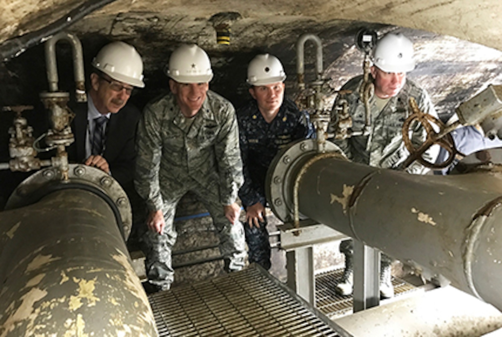 Kanto Plains Fuel Director Steve Shultz, left, explains the unique aspects of the challenging topography and infrastructure onboard Defense Fuel Support Point Hakozaki on the island of Azuma located within Tokyo Bay, Japan, to DLA Energy Commander Air Force Brig. Gen. Martin Chapin, second from left, and other leaders. The underground tunnel at DFSP Hakozaki provides access to valves and piping for a tank originally constructed in 1927.