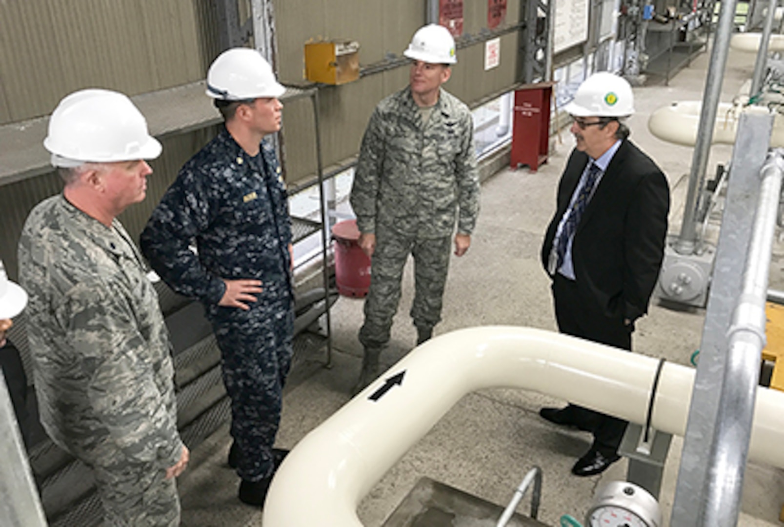 Navy Lt. Cmdr. Joe Bossi, Fleet Logistics Center Yokosuka fuel director, shows DLA Energy Commander Air Force Brig. Gen. Martin Chapin (second from right) and other leaders a recently completed project that improves fuel pumping capability at Defense Fuel Support Point Hakozaki on the island of Azuma located within Tokyo Bay, Japan, Oct. 28. 