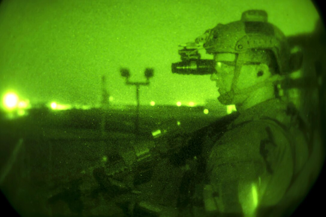As seen through a night-vision device, an Army Special Forces soldier provides security during a night infiltration and exfiltration exercise during Southern Strike 17 at the Gulfport Combat Readiness Training Center, Miss., Oct. 26, 2016. Air Force photo by Senior Airman Trevor T. McBride