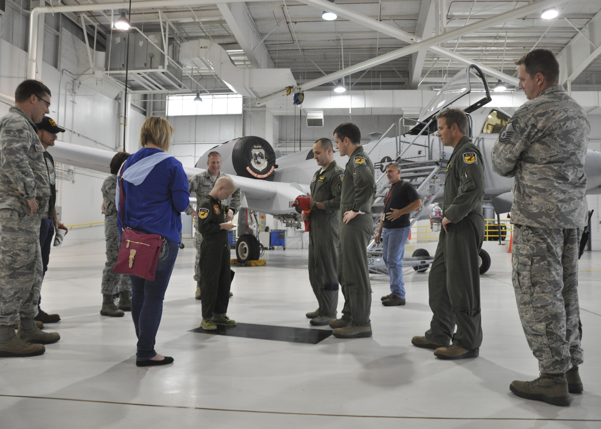 Members of the 442nd Fighter Wing welcome Britton Whiteside, honorary "pilot of the day," and his family in the A-10 Thunderbolt II hangar at Whiteman Air Force Base, Mo., November 3, 2016. The Whitesides traveled over an hour from Archie, Mo., to spend the day at Whiteman AFB as an uplifting day for Britton before his last round of chemotherapy. Britton was diagnosed with kidney cancer approximately four months prior to his visit at Whiteman. (U.S. Air Force photo/Senior Airman Missy Sterling)