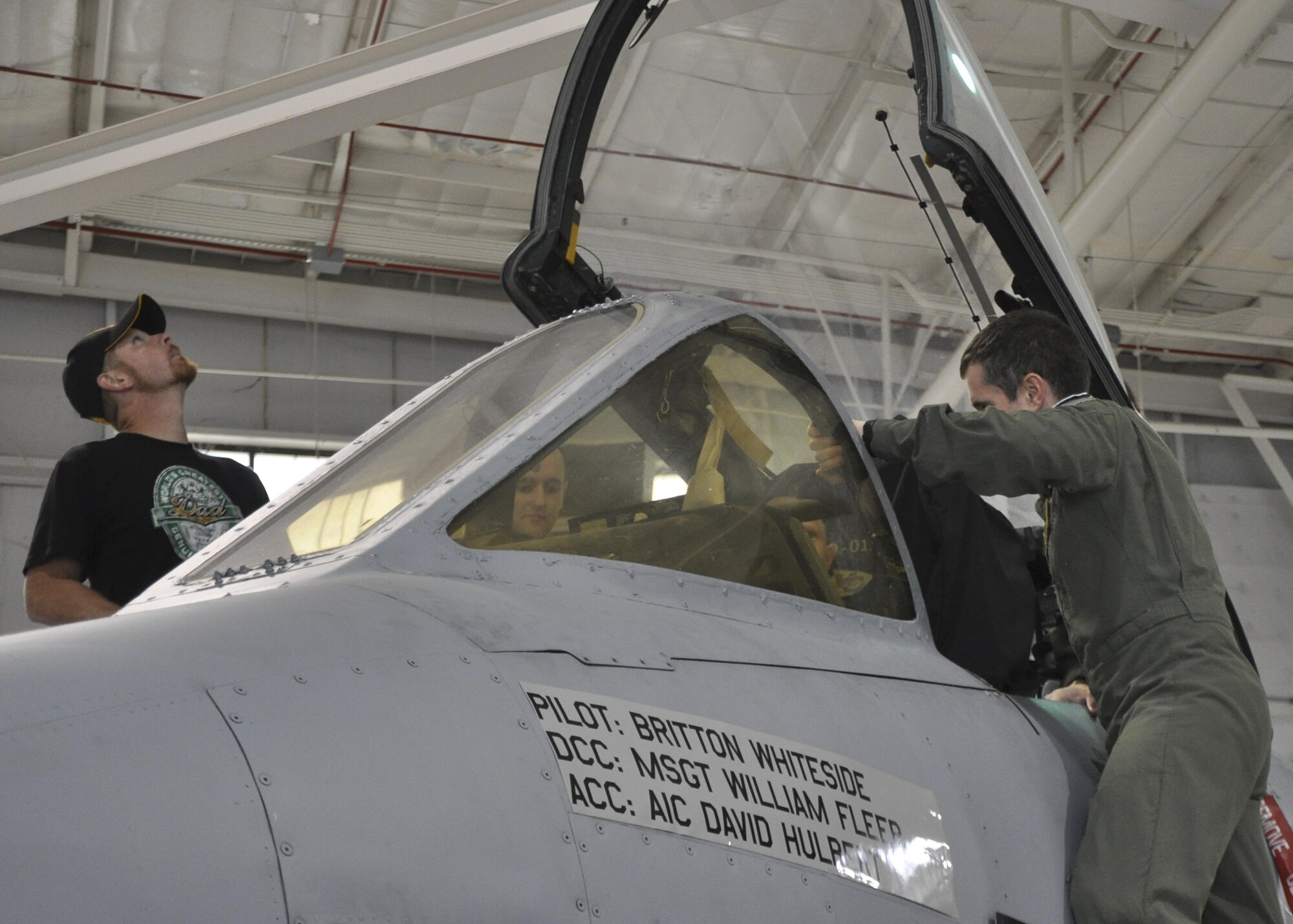 U.S. Air Force Capt. Eric Hickernell, 303rd Fighter Squadron pilot, explains the instrumental systems in an A-10 Thunderbolt II cockpit to Britton Whiteside, honorary "pilot of the day," at Whiteman Air Force Base, Mo., November 3, 2016. Britton was guided up the boarding ladder where he noticed his name on the side of the aircraft placed there by the 442nd Maintenance Squadron. (U.S. Air Force photo/Senior Airman Missy Sterling)