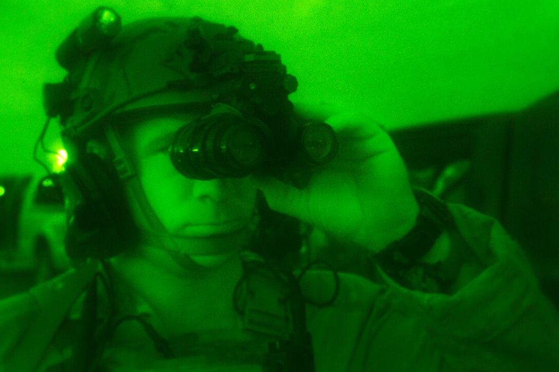 As seen through a night-vision device, a special operations service member calibrates his night vision equipment before a room clearing and close quarters battle operation during Southern Strike 17 at Naval Station Pascagoula, Miss., Oct. 26, 2016. Air Force photo by Tech. Sgt. Gregory Brook
