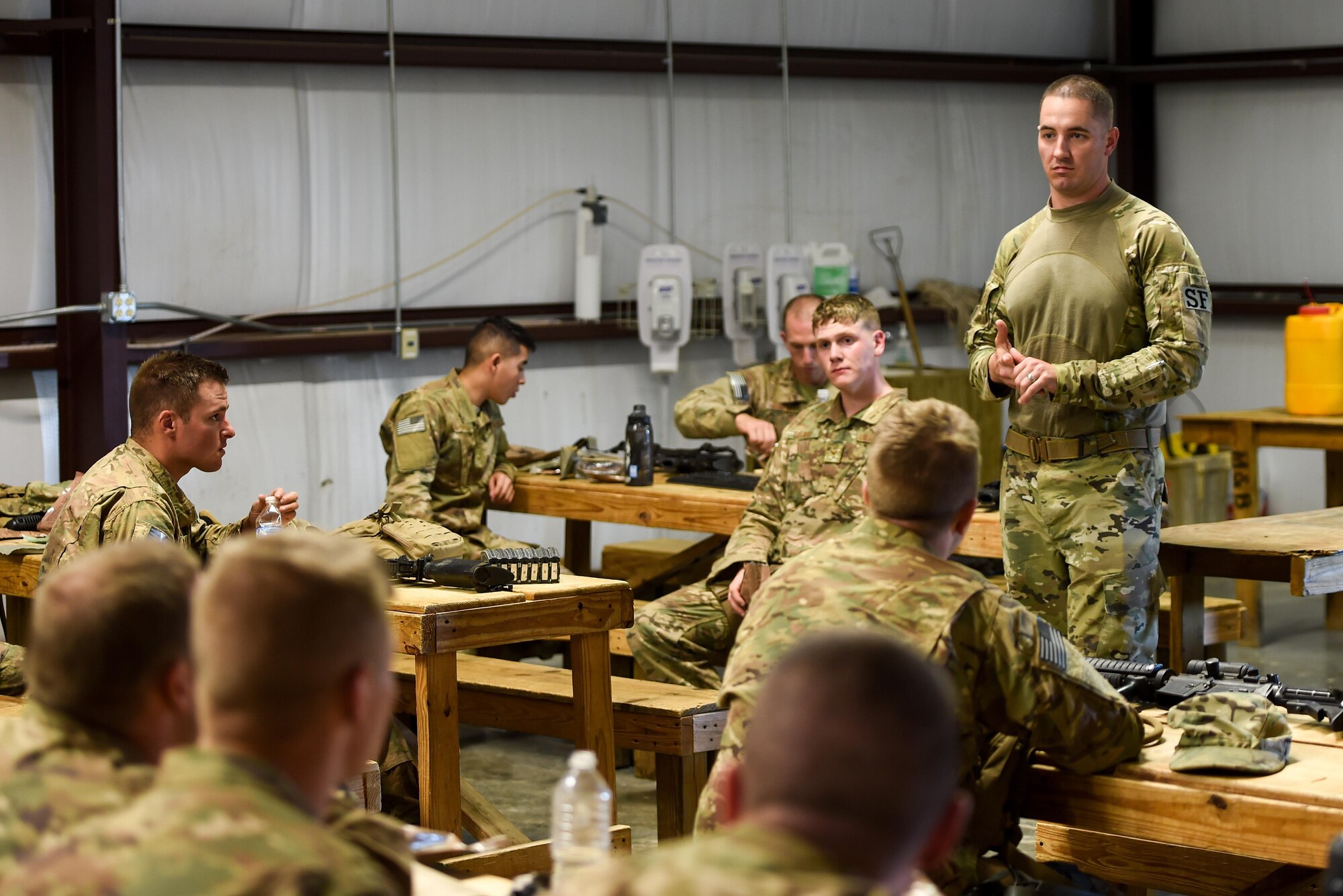 Capt. Justin May, operations officer for the 1st Special Operations Security Forces Squadron, discusses a mission in an after-action report during Task Force Exercise Southern Strike at Camp Shelby, Miss., Oct. 25, 2016. After-action reports are used to discuss areas of a mission that could be improved. (U.S. Air Force photo by Senior Airman Jeff Parkinson)