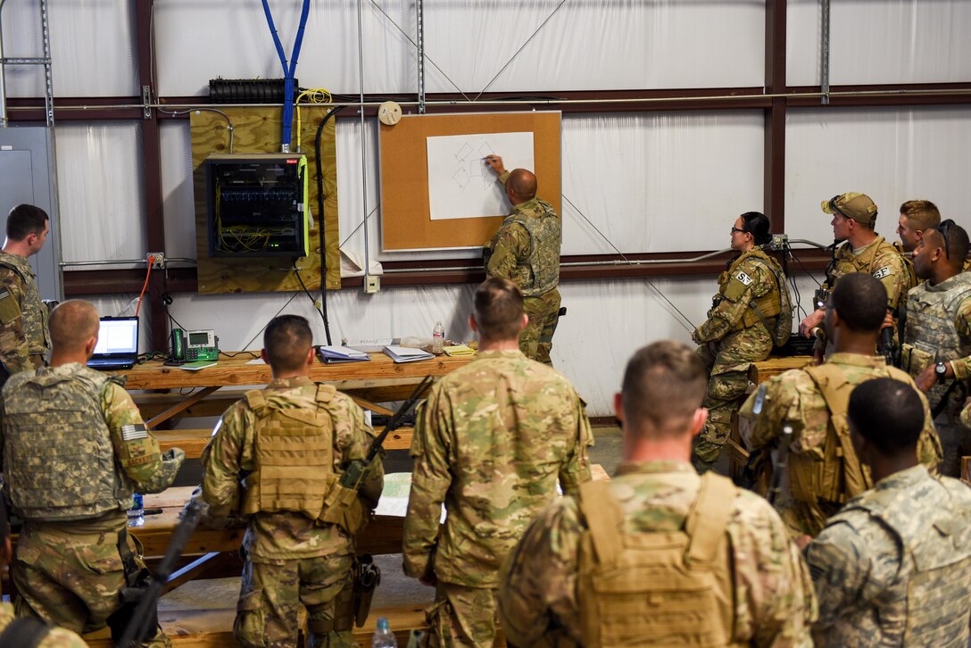 Air Commandos with the 1st Special Operations Mission Support Group are briefed prior to a training mission during Task Force Exercise Southern Strike at Camp Shelby, Miss., Oct. 25, 2016. During the mission students were evaluated on their ability to respond to a possible IED along their route, provide security while meeting with village leaders and finally - react to enemy weapons fire during their convoy’s return back to base. (U.S. Air Force photo by Senior Airman Jeff Parkinson)