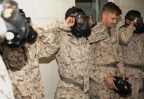 Lance Cpl. Carlos Rodarte Jr., 3rd Platoon, Company C, Fleet Anti-Terrorism Security Team, Marine Corps Security Force Regiment, breaks the seal of his M50 gas mask during chemical, biological, radioactive, and nuclear defense training, 2 Nov. at the gas chamber aboard Naval Station Norfolk. Marines must properly secure a gas mask after being exposed to o-chlorobenzylidene malonitrile gas, or CS gas, clear the mask so that they are able to breathe and continue with their mission. (Official U.S. Marine Corps photo by Sgt. Kayla D. Rivera/ Released)