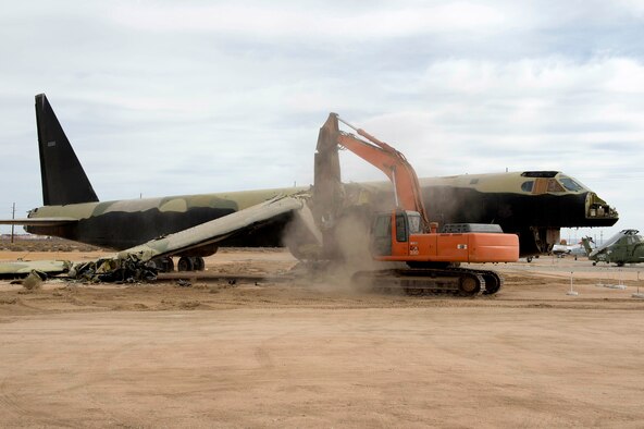 A wrecker dismantles B-52 56-0585 in front of the Air Force Flight Test Museum Oct. 27. The aircraft arrived at the AFFT Museum in 1983, and over the years its condition has deteriorated. Returning it to museum standards wasn't cost-effective. The Vietnam-era combat aircraft's dismantling will provide parts for other B-52Ds at six other aviation museums throughout the country. (U.S. Air Force photo by Joseph Pol Gocong)