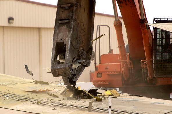 A wrecker dismantles B-52 56-0585 in front of the Air Force Flight Test Museum Oct. 27. The aircraft arrived at the AFFT Museum in 1983, and over the years its condition has deteriorated. Returning it to museum standards wasn't cost-effective. The Vietnam-era combat aircraft's dismantling will provide parts for other B-52Ds at six other aviation museums throughout the country. (U.S. Air Force photo by Joseph Pol Gocong)