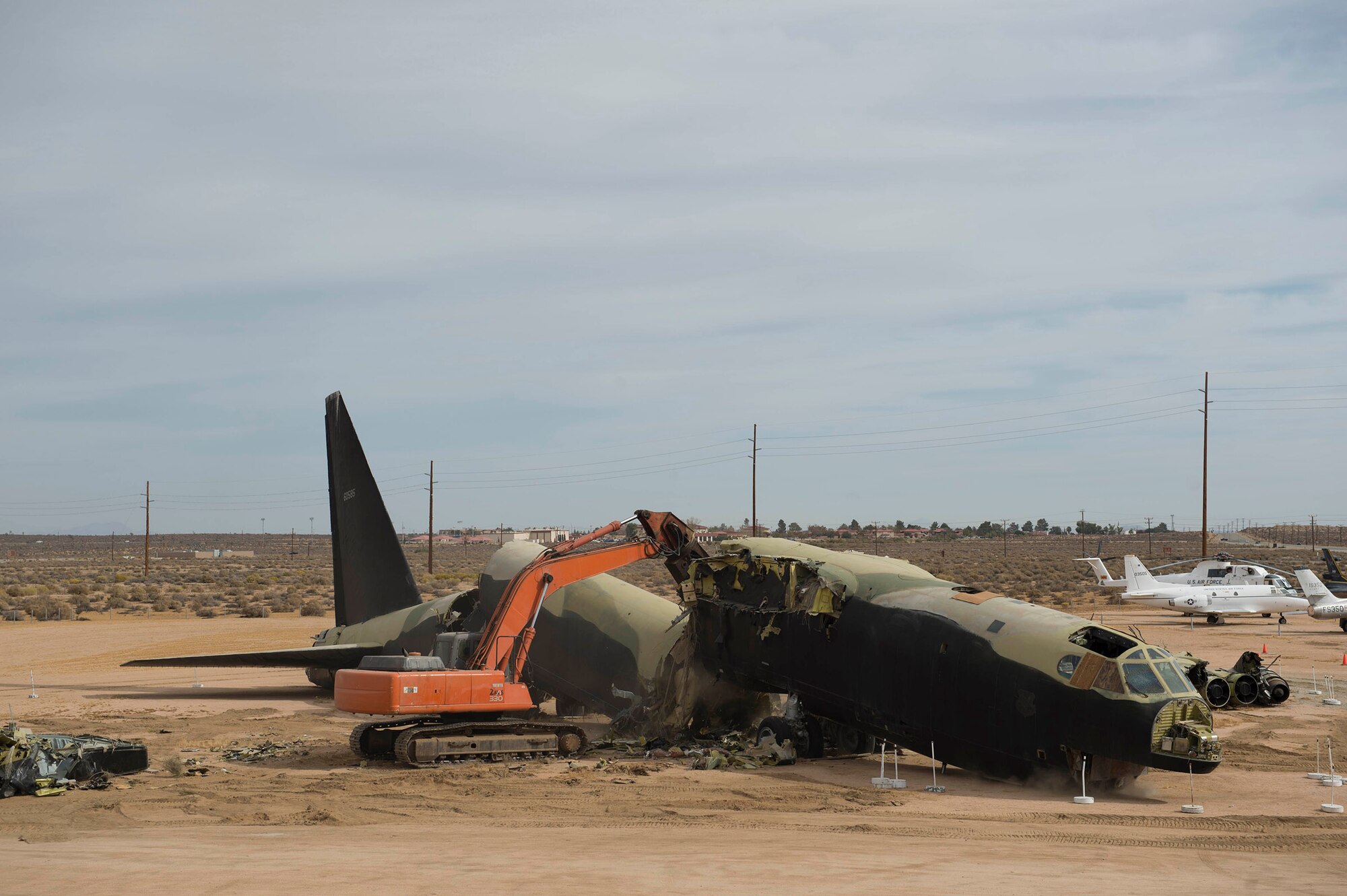 A wrecker dismantles B-52 56-0585 in front of the Air Force Flight Test Museum Oct. 27. The aircraft arrived at the AFFT Museum in 1983, and over the years the condition of the aircraft had deteriorated. Returning it to museum standards was not cost-effective. The Vietnam-era combat aircraft's dismantling will provide parts for other B-52Ds at six other aviation museums throughout the country. (U.S. Air Force photo by Joseph Pol Gocong)
