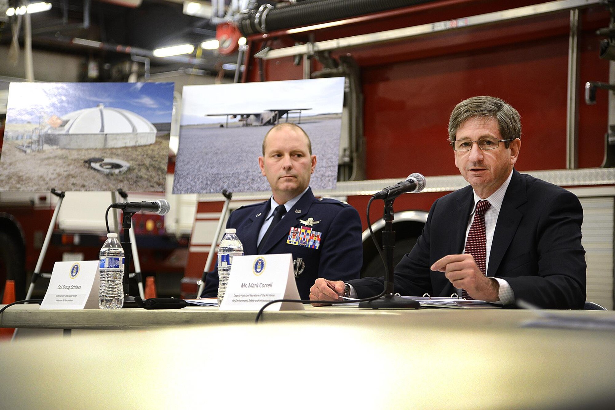 As Col. Doug Schiess, 21st Space Wing commander listens, Mr. Mark Correll, Deputy Assistant Secretary of the Air Force for Environment, Safety and Infrastructure answers a question from a reporter at Peterson Air Force Base Fire Station One during a media roundtable Nov. 2, 2016. Correll and his team were visiting Peterson to discuss the perfluorinated compounds contamination issue in the Fountain, Security and Widefield communities’ water supply aquifer. (US Air Force photo by Rob Bussard)