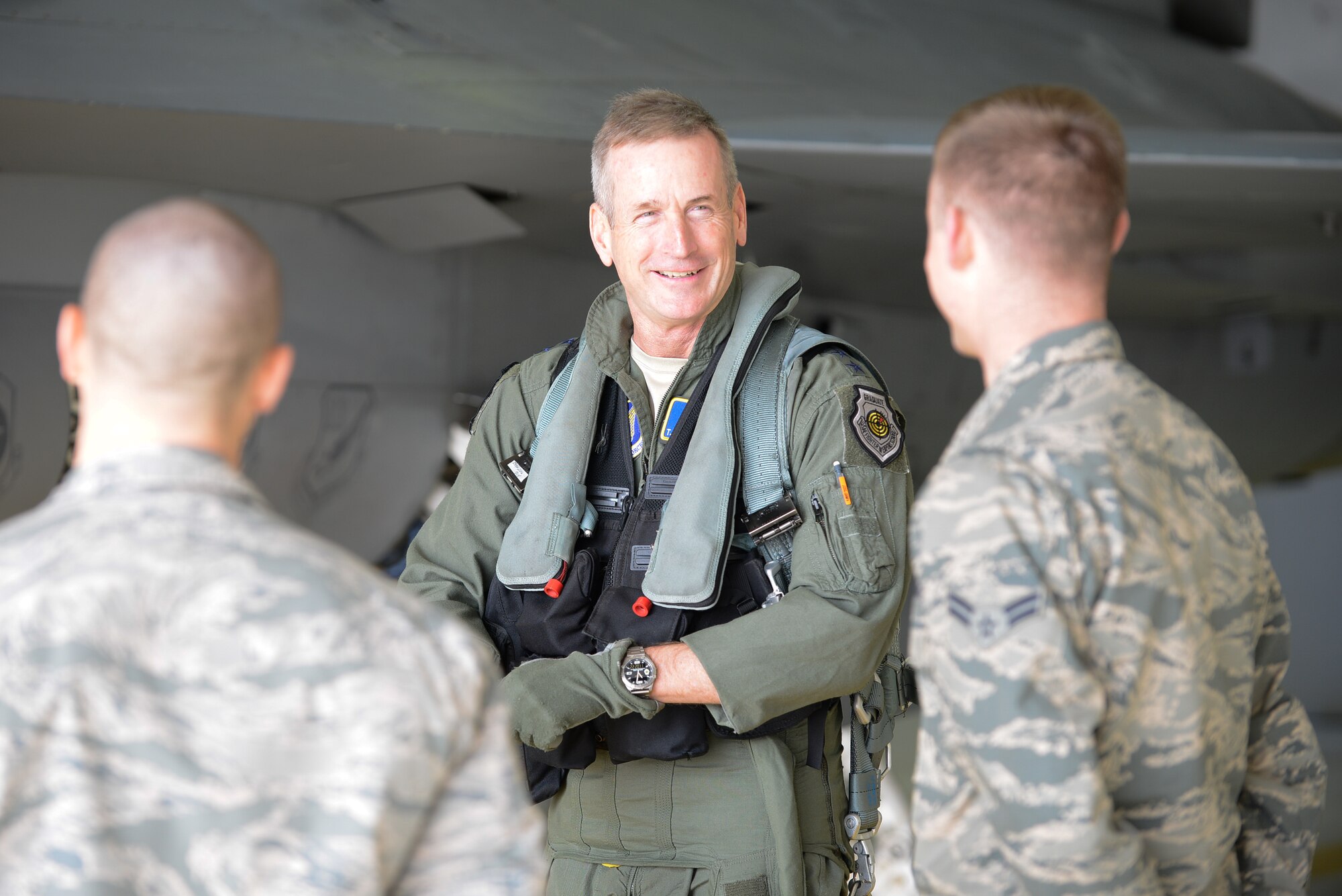 U.S. Air Force Gen. Terrence O’Shaughnessy, middle, Pacific Air Forces commander, speaks with Staff Sgt. Alvaro Perez Leblanc, left, and Airman 1st Class Joseph Clark, right, 36th Aircraft Maintenance Unit crew chiefs, before flying in an F-16 Fighting Falcon at Osan Air Base, Republic of Korea, Nov. 4, 2016. After his flight, O’Shaughnessy rewarded the crew chiefs with his coin for their contributions and excellence to the 51st Fighter Wing mission. (U.S. Air Force photo by Senior Airman Dillian Bamman)