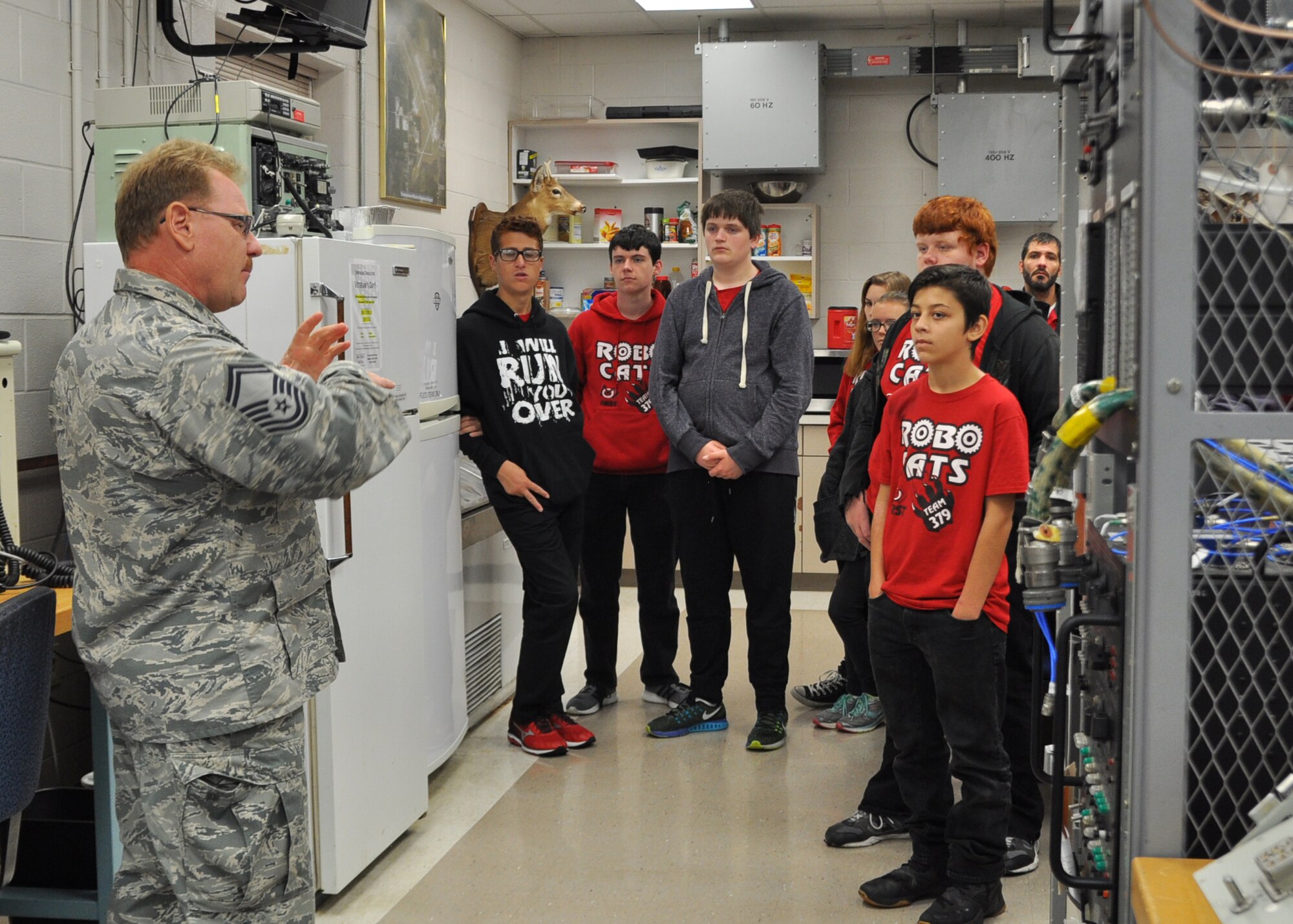 Senior Master Sgt. Gary Kohut, superintendent of the avionics shop here, discusses his shop’s work with students from the FIRST Robotics Team 379 Robocats from Girard High School here, Oct. 21, 2016. The team visited several shops at YARS during their tour. (U.S. Air Force photo/Maj. Polly Orcutt)