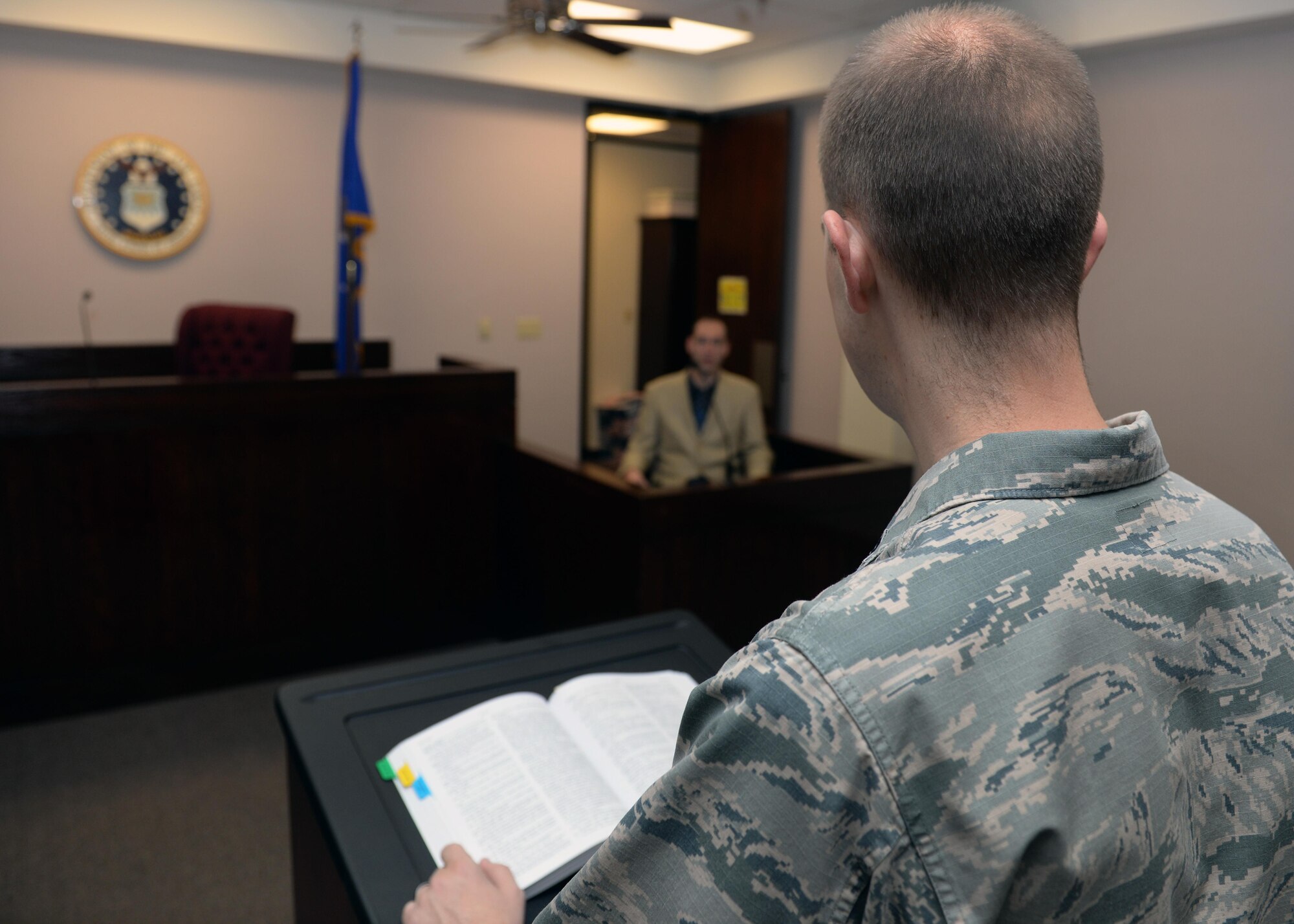 U.S. Air Force Capt. John Cane, 97th Air Mobility Wing chief of military justice, simulates hearing a witness testimony, Nov. 1, 2016, at Altus Air Force Base, Okla. The Base Legal Office helps base members with legal matters and services as well as advising commanders on legal proceedings. (U.S. Air Force Photo by Airman Jackson Haddon/ Released)