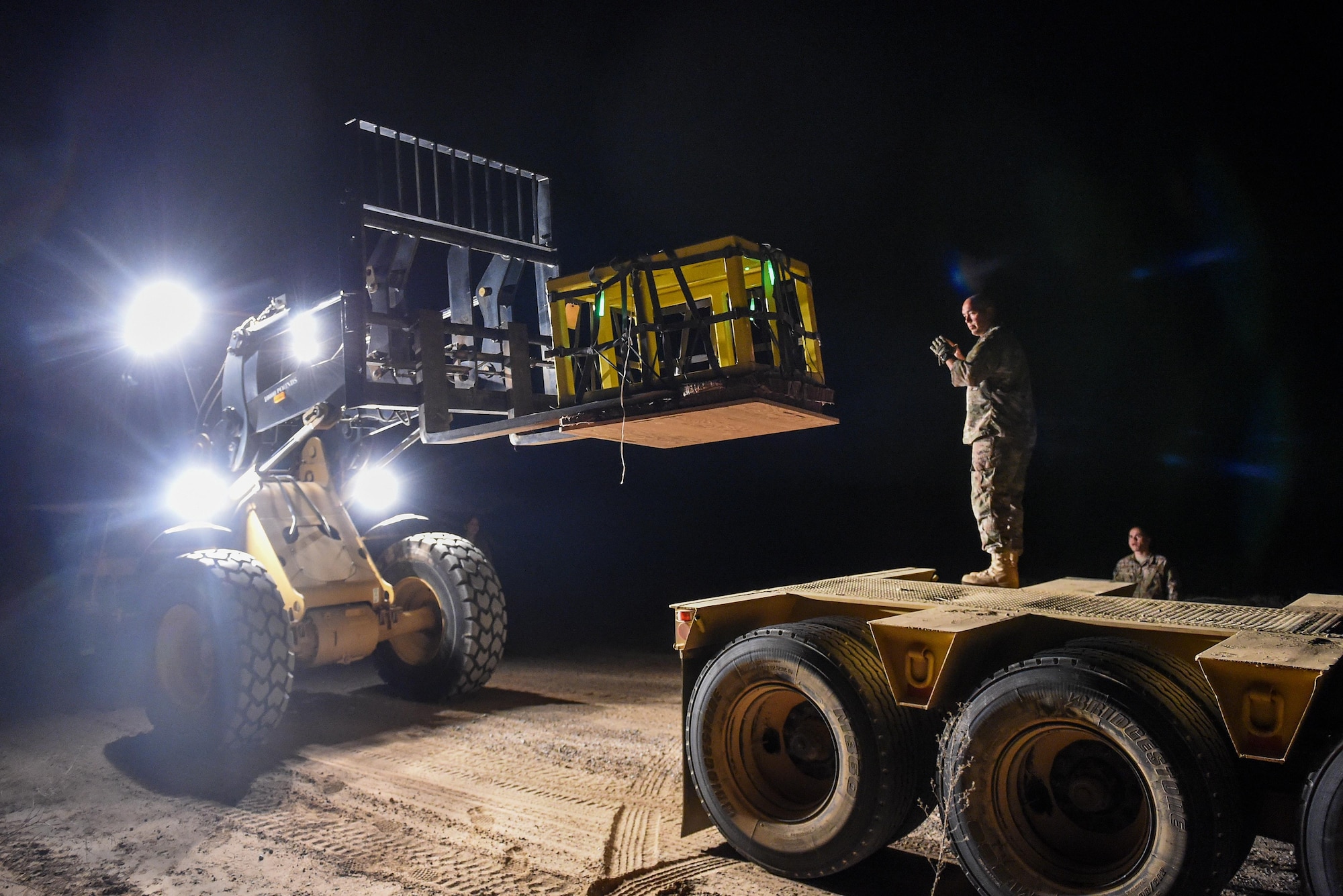 Air Commandos move cargo bundles onto a truck during Task Force Exercise Southern Strike at Camp Shelby, Miss., Nov 1, 2016. Southern Strike is a large-scale, conventional and special operations exercise hosted by the Mississippi National Guard at the Gulfport Combat Readiness and Camp Shelby Joint Forces Training Centers. (U.S. Air Force photo by Senior Airman Jeff Parkinson)