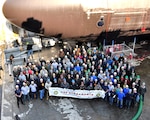 KITTERY, MAINE - Portsmouth Naval Shipyard workers gather in front of USS Alexandria (SSN 757) during its engineering overhaul, the fastest in the Navy's history. 