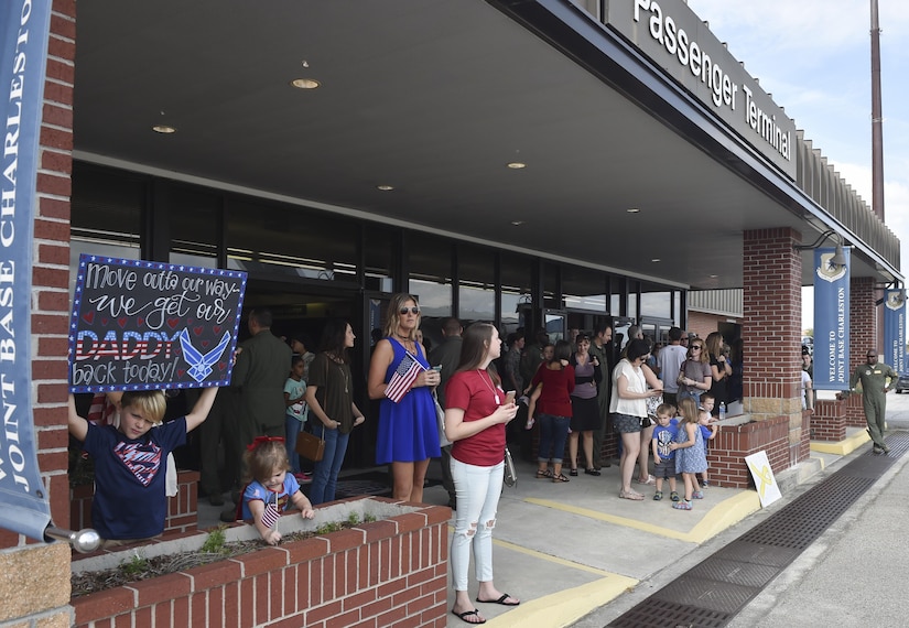 Family, friends and fellow Airmen gather outside of the passenger terminal in anticipation of their loved ones and friends returning home from a deployment in Southwest Asia Nov. 2, 2016, at Joint Base Charleston, South Carolina. The 14th, 15th and 16th Airlift Squadrons within the 437th Airlift Wing all had members returning from the deployment. The 437th AW commands the base's premier active-duty flying wing. The wing flies and maintains one of the largest fleets of C-17 aircraft in the Air Force, providing a significant portion of Air Mobility Command’s Global Reach airlift capability. 