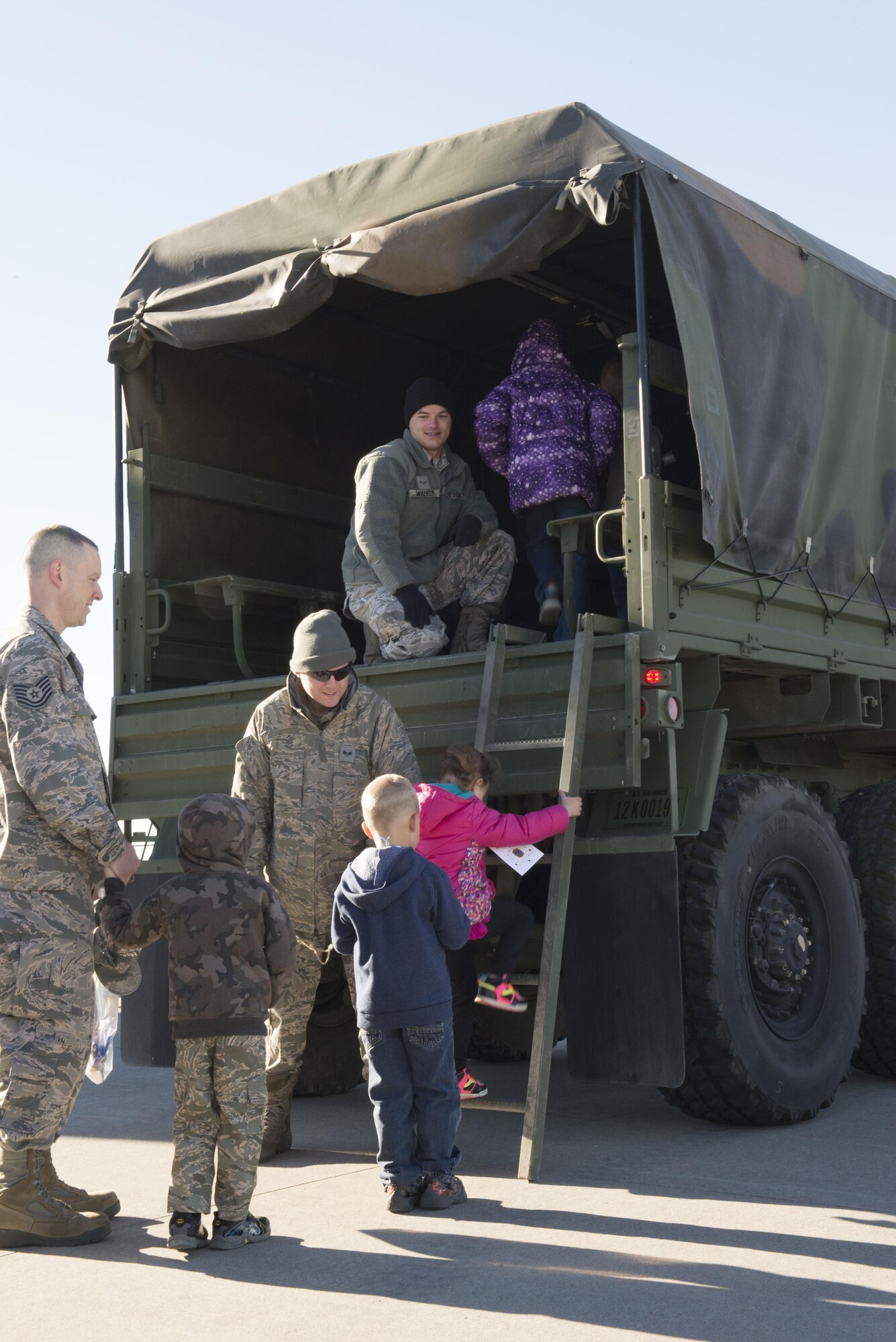 Airmen help a group of children onto a five-ton truck at the Kids Understanding Deployment Operations day Oct. 21, 2016, at Mountain Home Air Force Base, Idaho. The kids were given their own set of KUDOS dog tags, similar to the ones their parents wear. (U.S. Air Force photo by Airman Jeremy D. Wolff/Released)