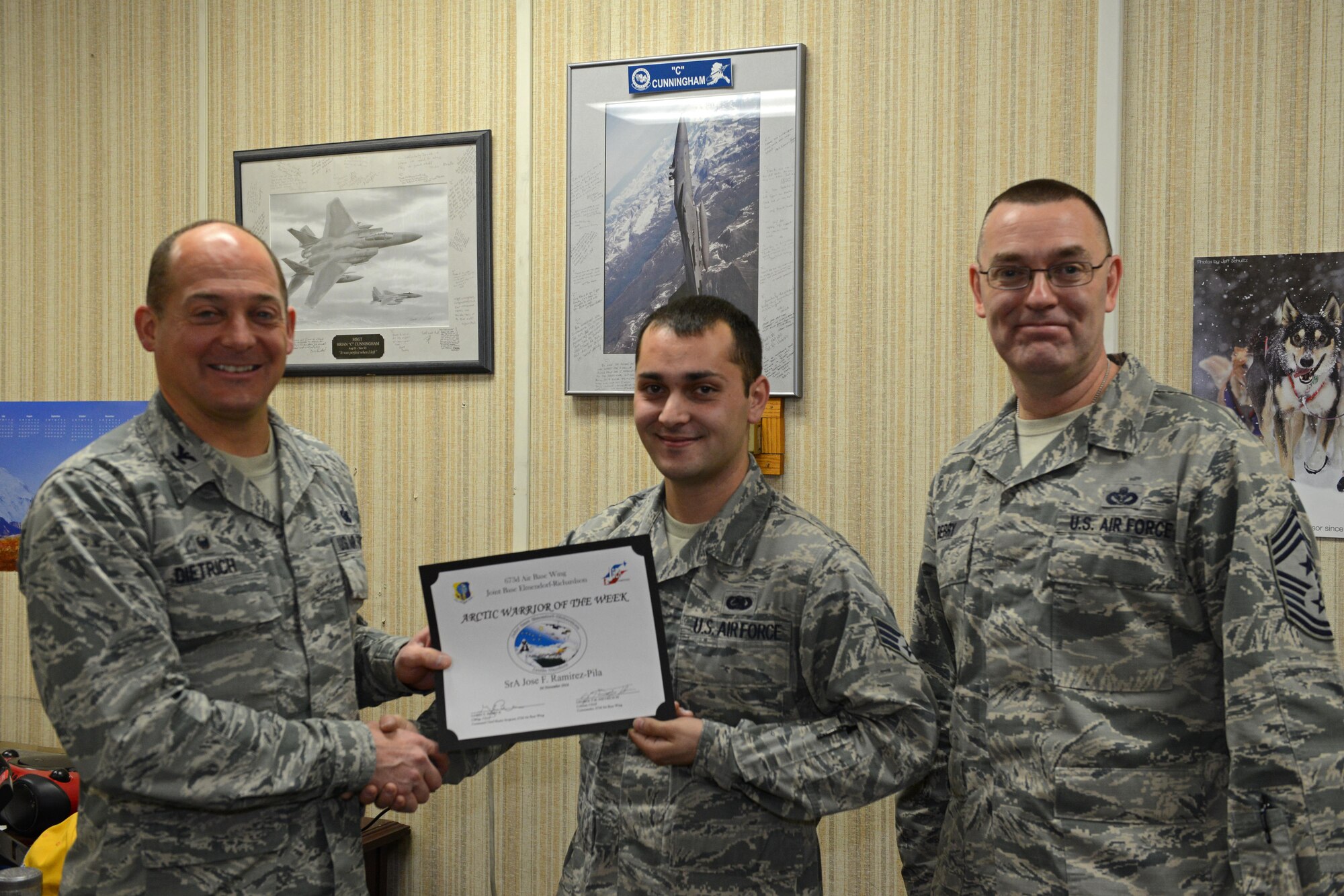 Senior Airman Jose Ramirez Pila, 673d Logistics Readiness Squadron individual protective equipment technician, receives the Arctic Warrior of the Week Award at Joint Base Elmendorf-Richardson, Alaska, Nov. 04, 2016.