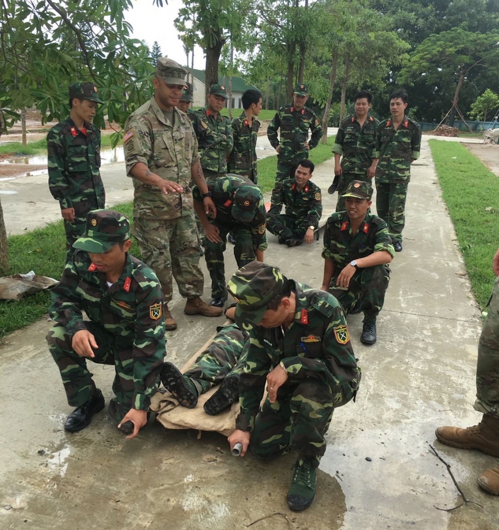 In this file photo, U.S. Army instructors from 18th Medical Command (Deployment Support), supervise and observe the Vietnamese army medical students during a period of instruction on the proper methods to move a casualty with a litter during phase one of the Humanitarian Mine Action training held Aug. 8-31, 2016 in Son Tay, Vietnam.