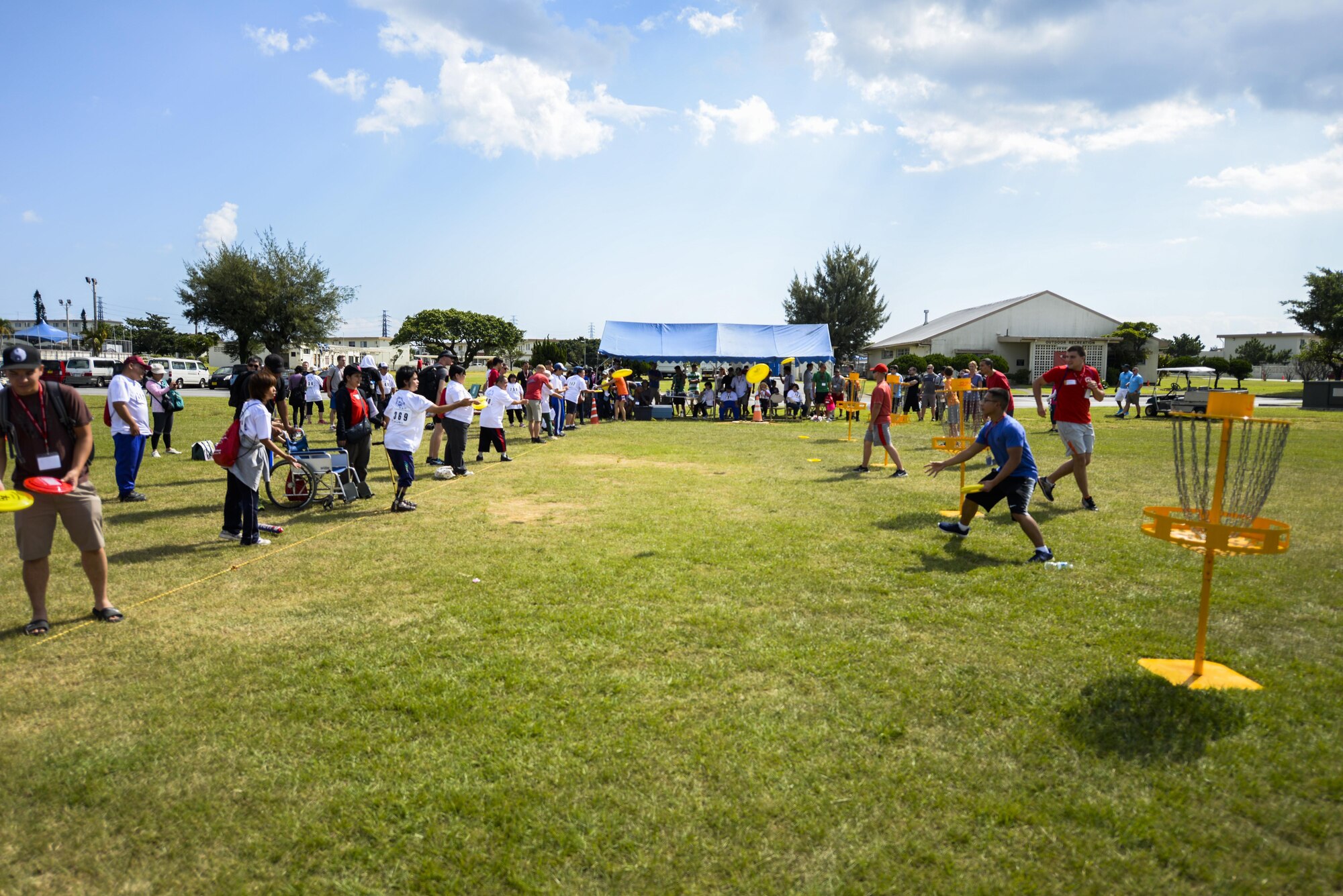 Kadena Special Olympic athletes and their athlete buddies compete in the Frisbee toss challenge Nov. 5, 2016, at Kadena Air Base, Japan. Last year more than 2,300 volunteers assisted 1,460 athletes and nearly 600 artists in support of the competition, bowling tournament and art show. (U.S. Air Force photo by Senior Airman Stephen G. Eigel/released)
